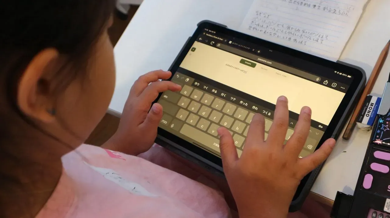 A child deeply focused on creating with YouWare